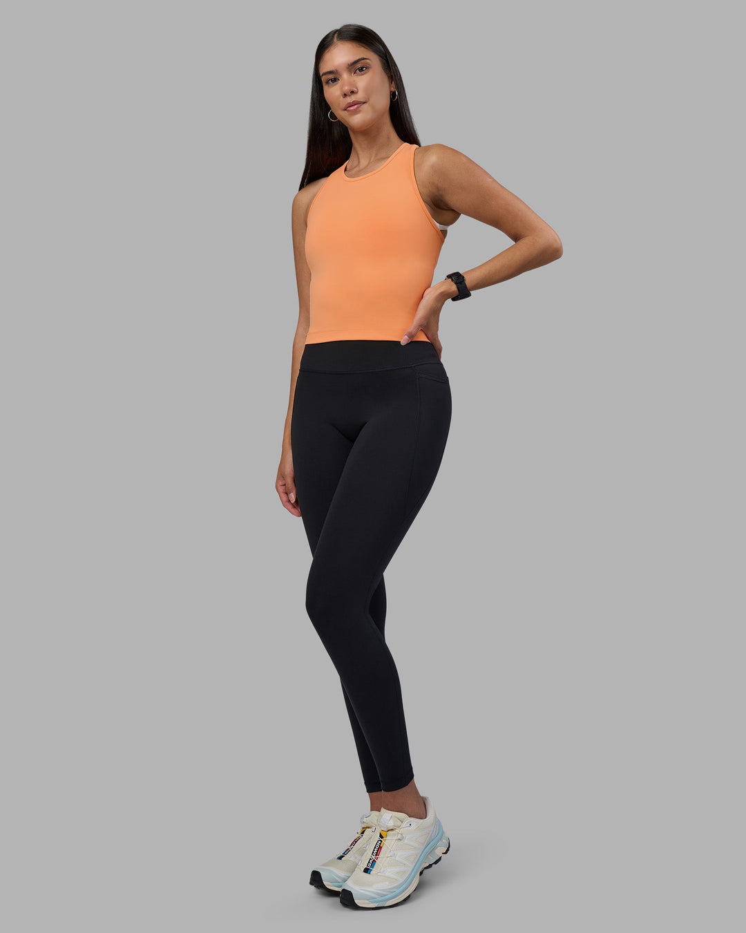 Woman wearing Flow Performance Tank 2.0 - Cantaloupe | Model:Rhiley | Size:S