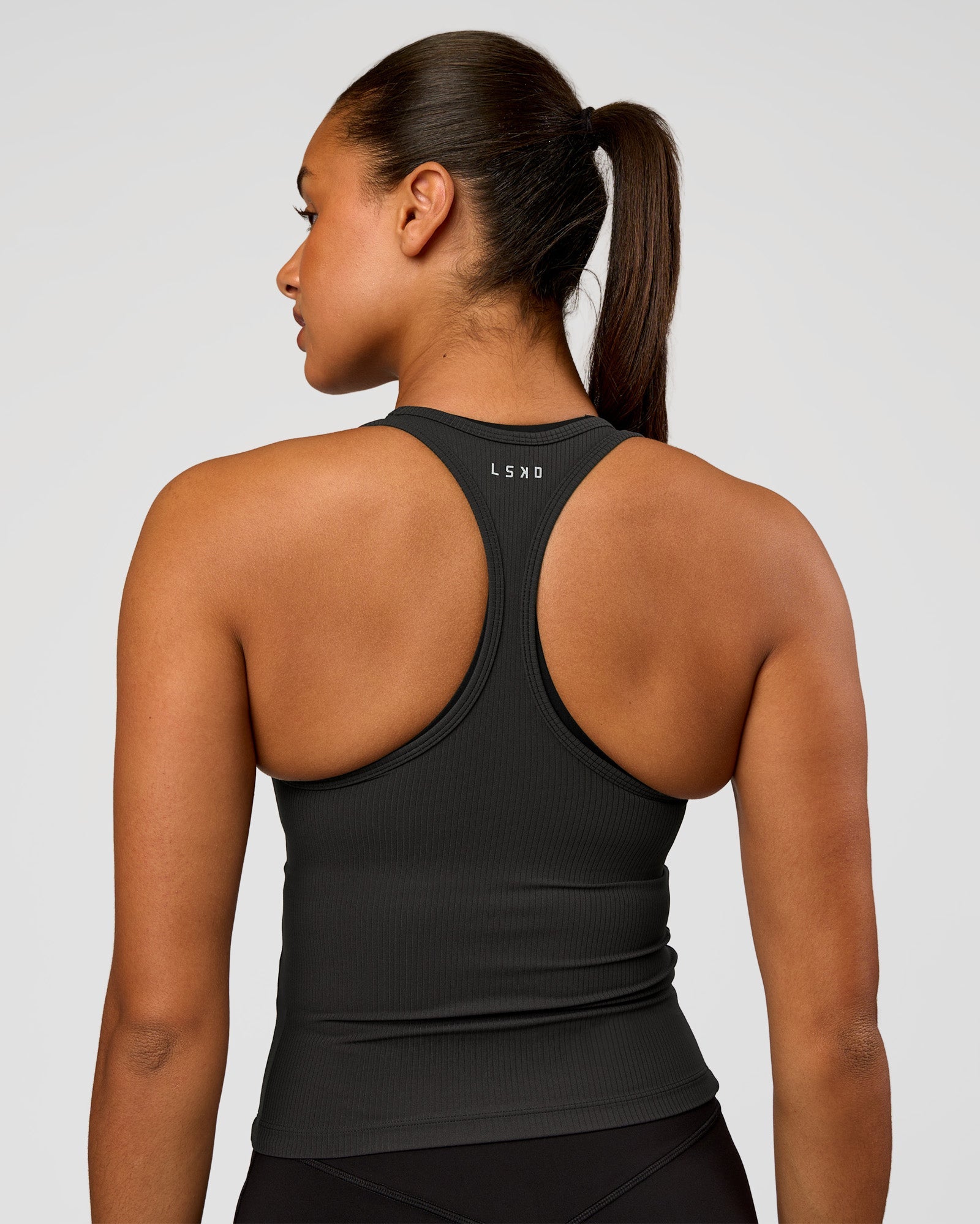 Woman wearing Flow Rib Scoop Neck Tank - Onyx | Model:Rosie | Size:S