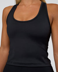 Woman wearing Flow Scoop Neck Performance Tank - Black | Model:Amity | Size:S