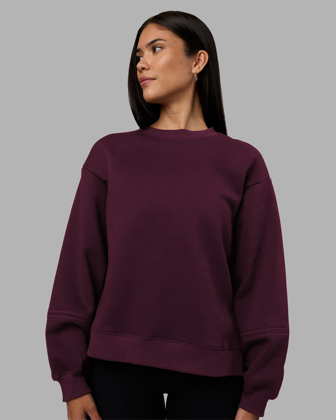 Woman wearing Full Form Fleece Sweater with Side Slits - Cherry Lacquer | Model:Rhiley | Size:S