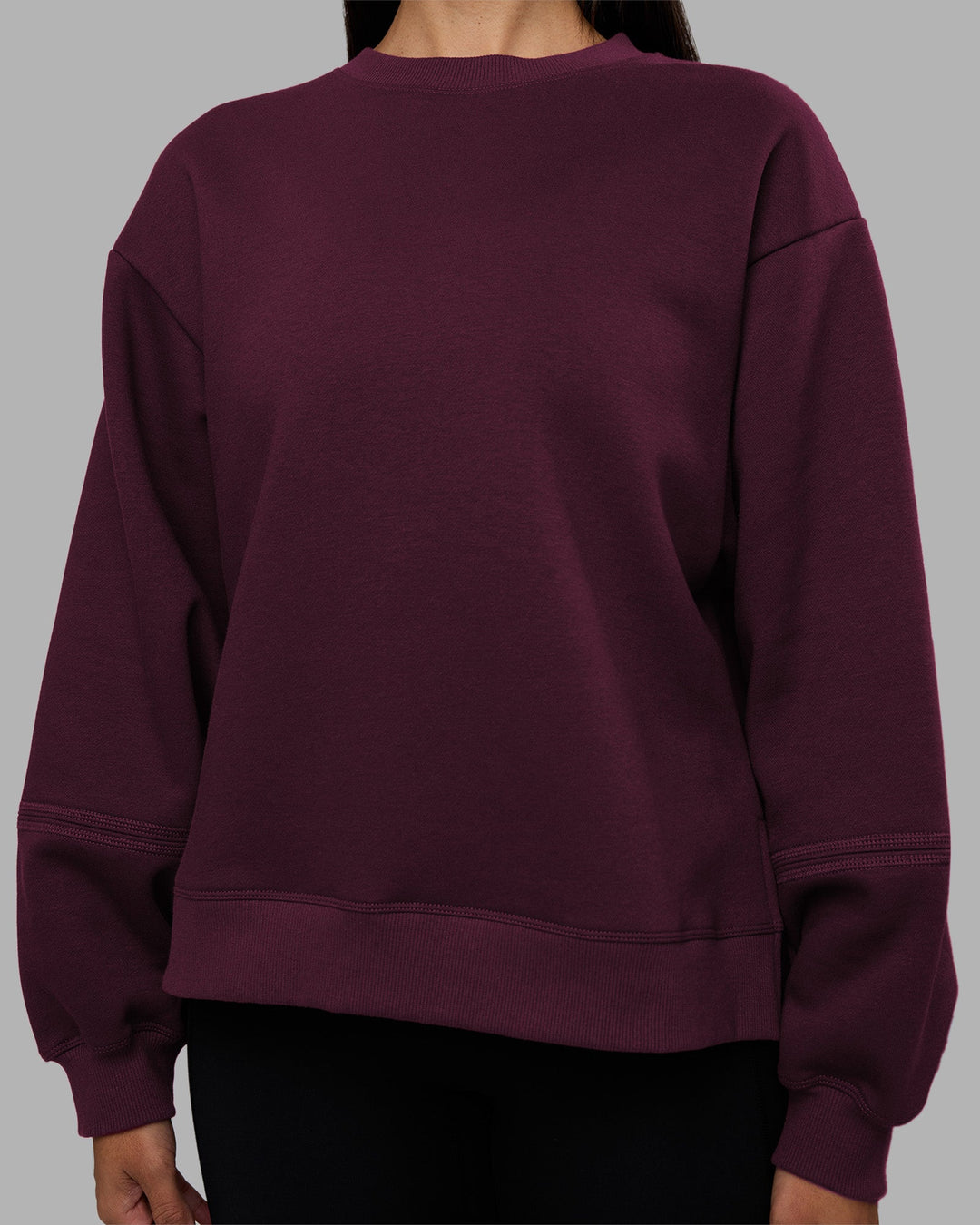 Woman wearing Full Form Fleece Sweater with Side Slits - Cherry Lacquer | Model:Rhiley | Size:S