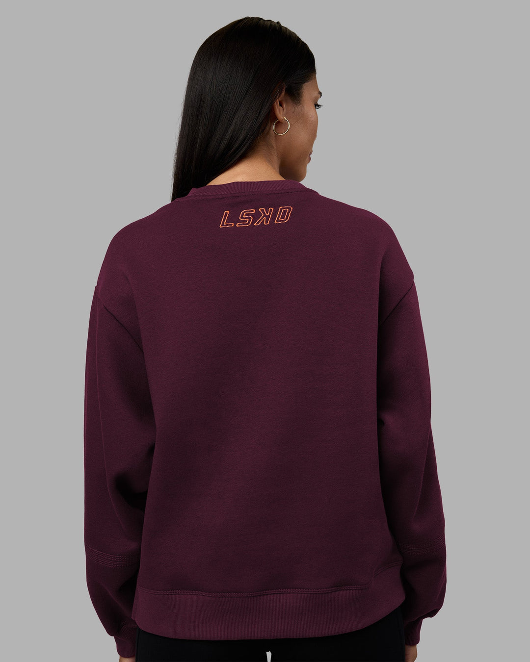 Woman wearing Full Form Fleece Sweater with Side Slits - Cherry Lacquer | Model:Rhiley | Size:S