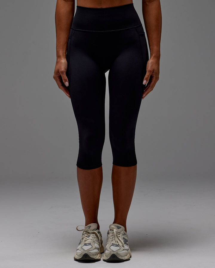 Woman wearing Fusion 3/4 Length Tight with Pockets in Black | Size:S
