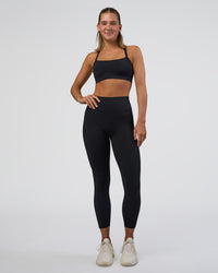Woman wearing Fusion Ultra High-Rise 7/8 Legging Pockets - Black | Model:Amity | Size:S