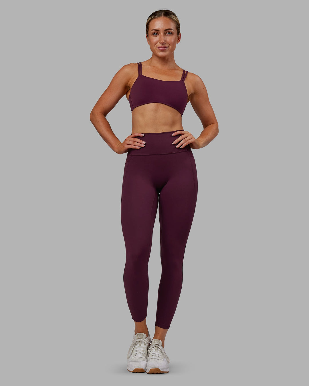 Woman wearing Fusion Ultra High-Rise 7/8 Legging Pockets - Cherry Lacquer | Model:Paris | Size:S - view 2