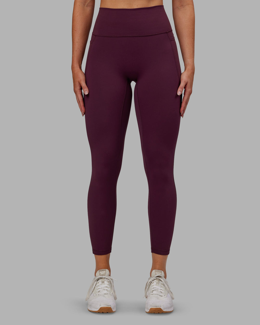 Woman wearing Fusion Ultra High-Rise 7/8 Legging Pockets - Cherry Lacquer | Model:Paris | Size:S - view 1