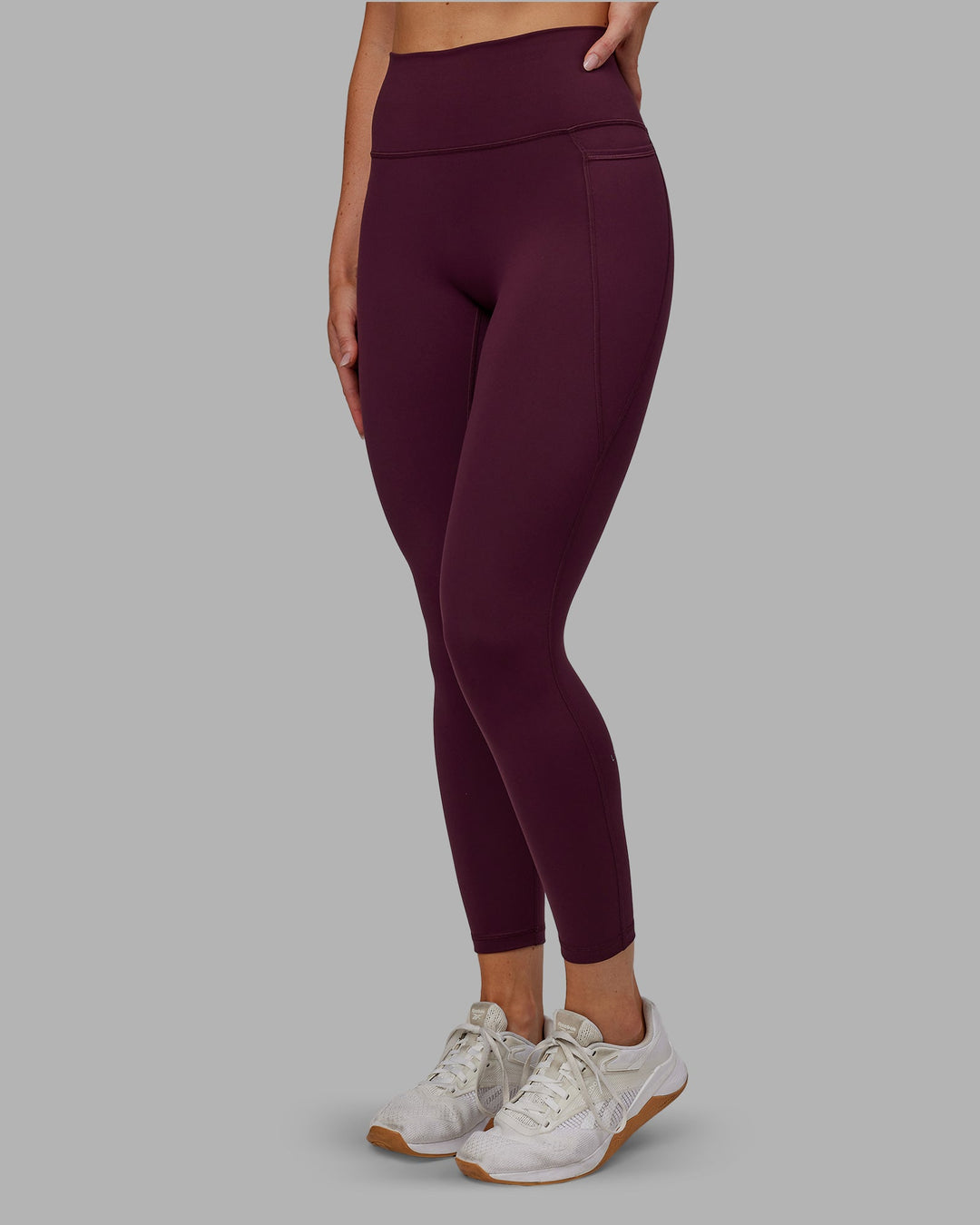 Woman wearing Fusion Ultra High-Rise 7/8 Legging Pockets - Cherry Lacquer | Model:Paris | Size:S - view 3