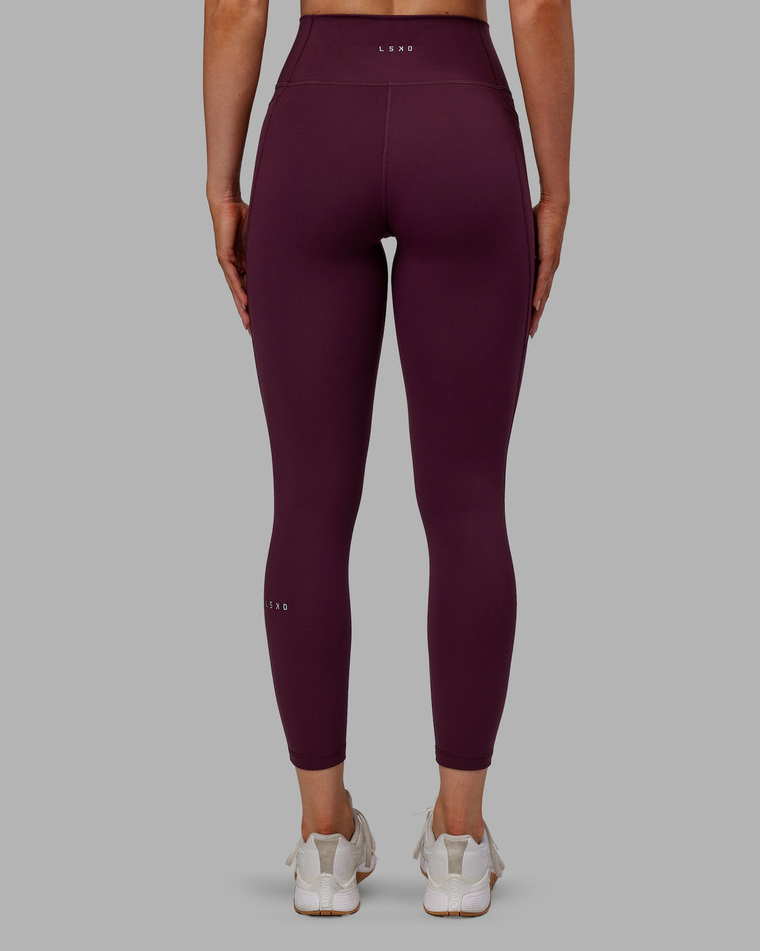 Woman wearing Fusion Ultra High-Rise 7/8 Legging Pockets - Cherry Lacquer | Model:Paris | Size:S - view 5