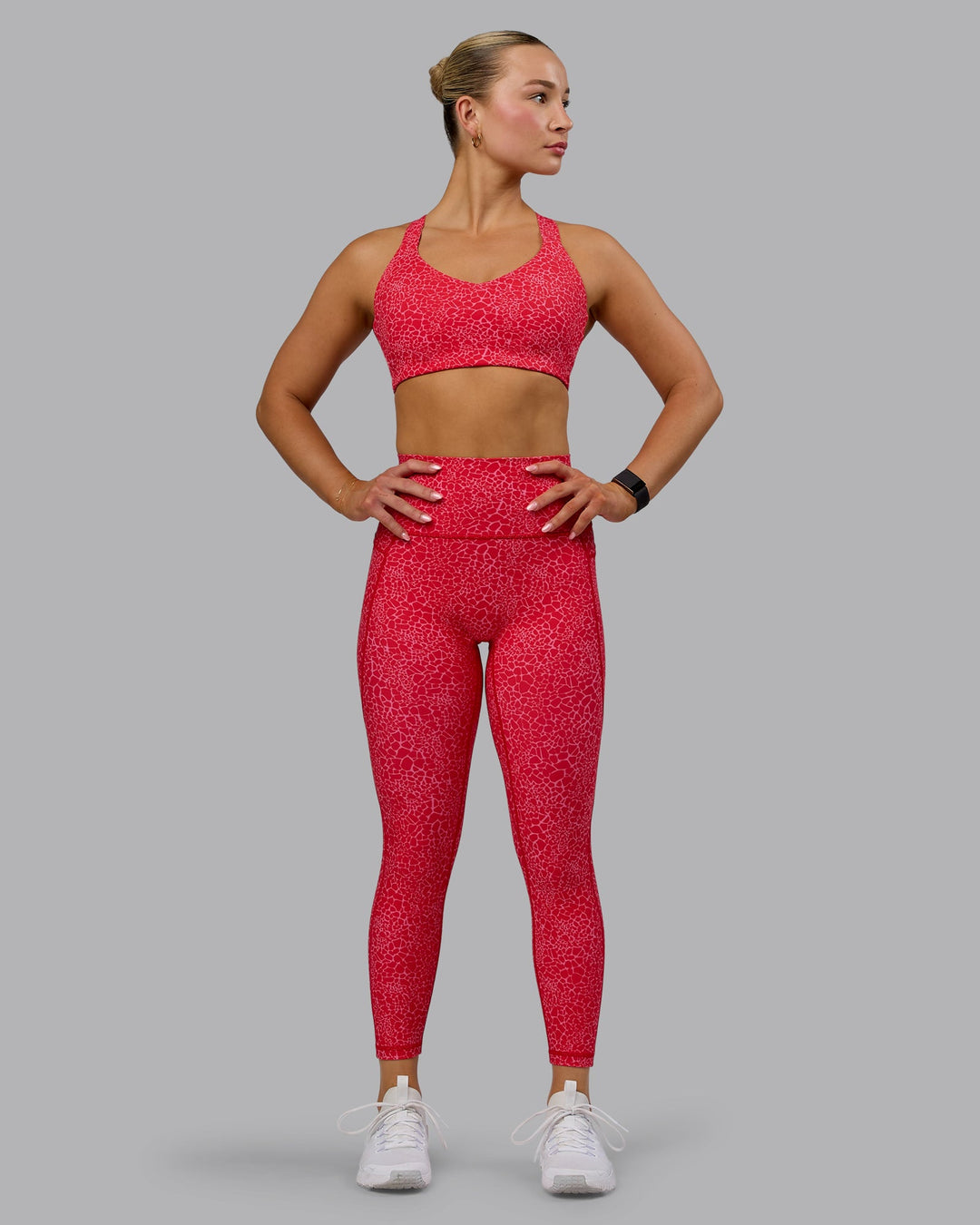 Woman wearing Fusion Ultra High-Rise 7/8 Legging Pockets - Red Vitality Print | Model:Halle | Size:S