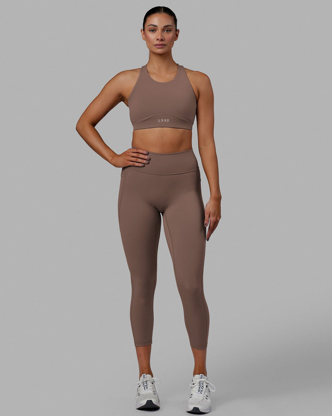 Woman wearing Fusion Ultra High-Rise 7/8 Legging Pockets - Deep Taupe | Model:Blaize | Size:S