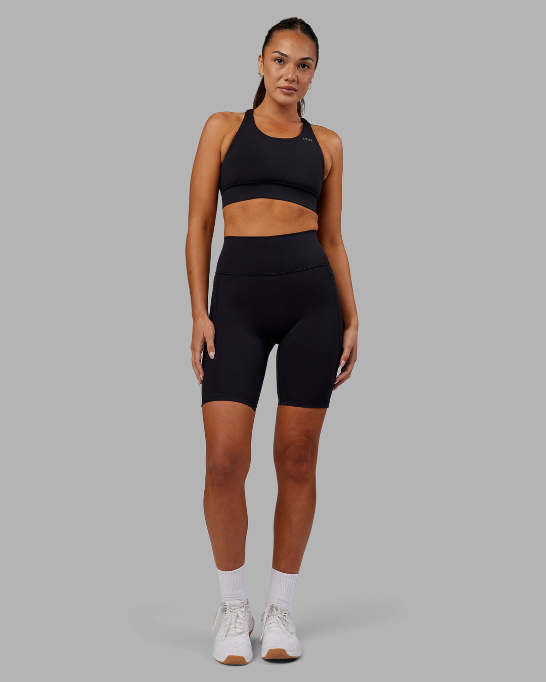 Woman wearing Fusion Ultra High-Rise 9&quot; Short Pockets - Black | Model:Kirstyn | Size:S