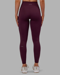 Woman wearing Fusion Ultra High-Rise Full Length Legging Pockets - Cherry Lacquer | Model:Paris | Size:S
