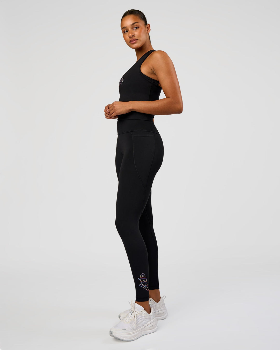Woman wearing Fusion Graphic Ultra High-Rise Full Length Legging Pockets - Black-Radiate | Model:Rosie | Size:S