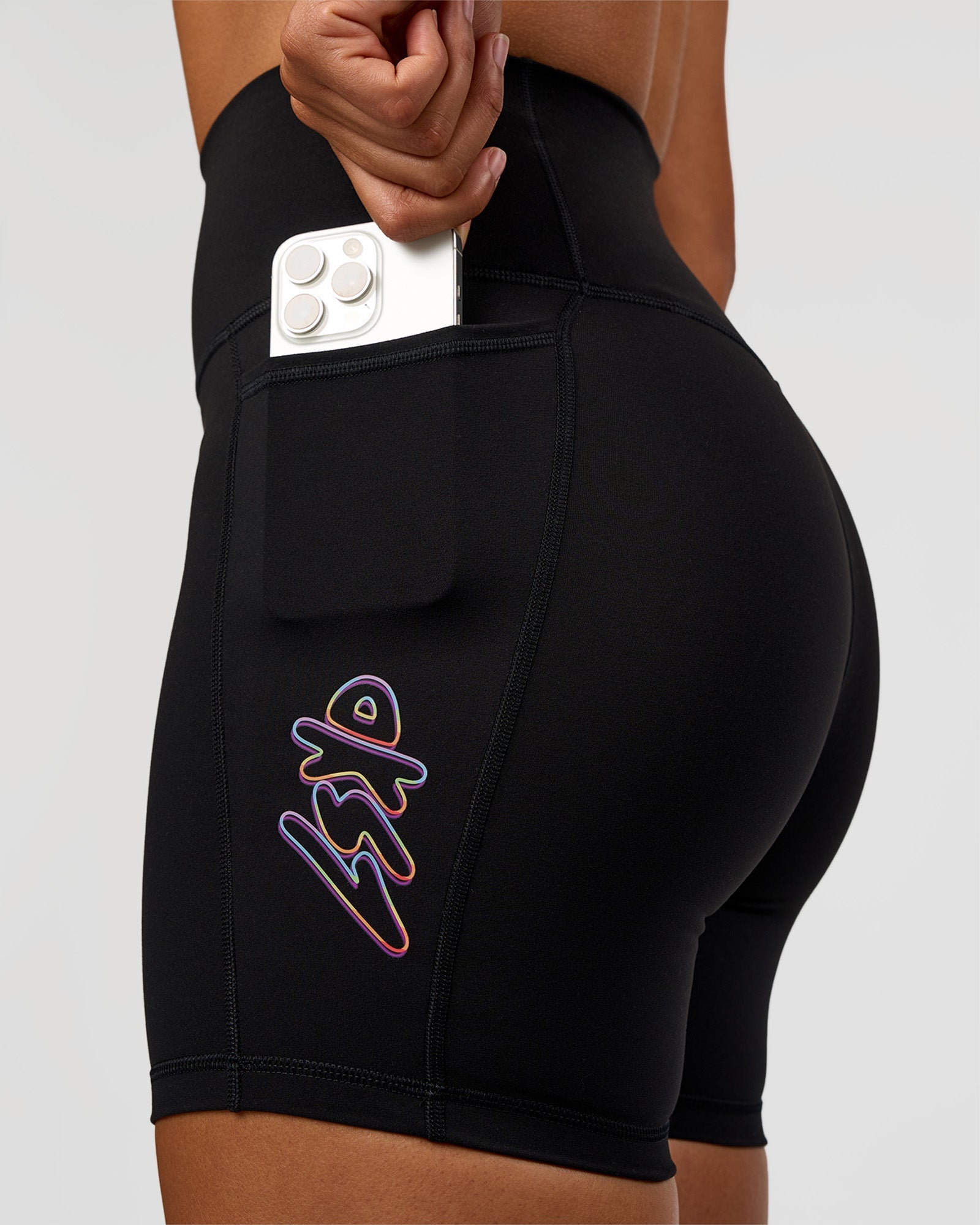 Woman wearing Fusion Graphic Ultra High-Rise 6" Short Pockets - Black-Radiate | Model:Rosie | Size:S