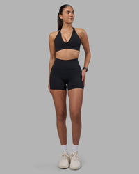 Woman wearing Fusion High-Rise 4" Short Pockets - Black | Model:Rhiley | Size:S