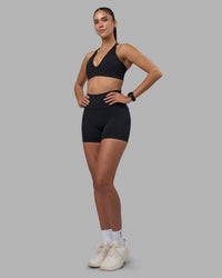 Woman wearing Fusion High-Rise 4" Short Pockets - Black | Model:Rhiley | Size:S