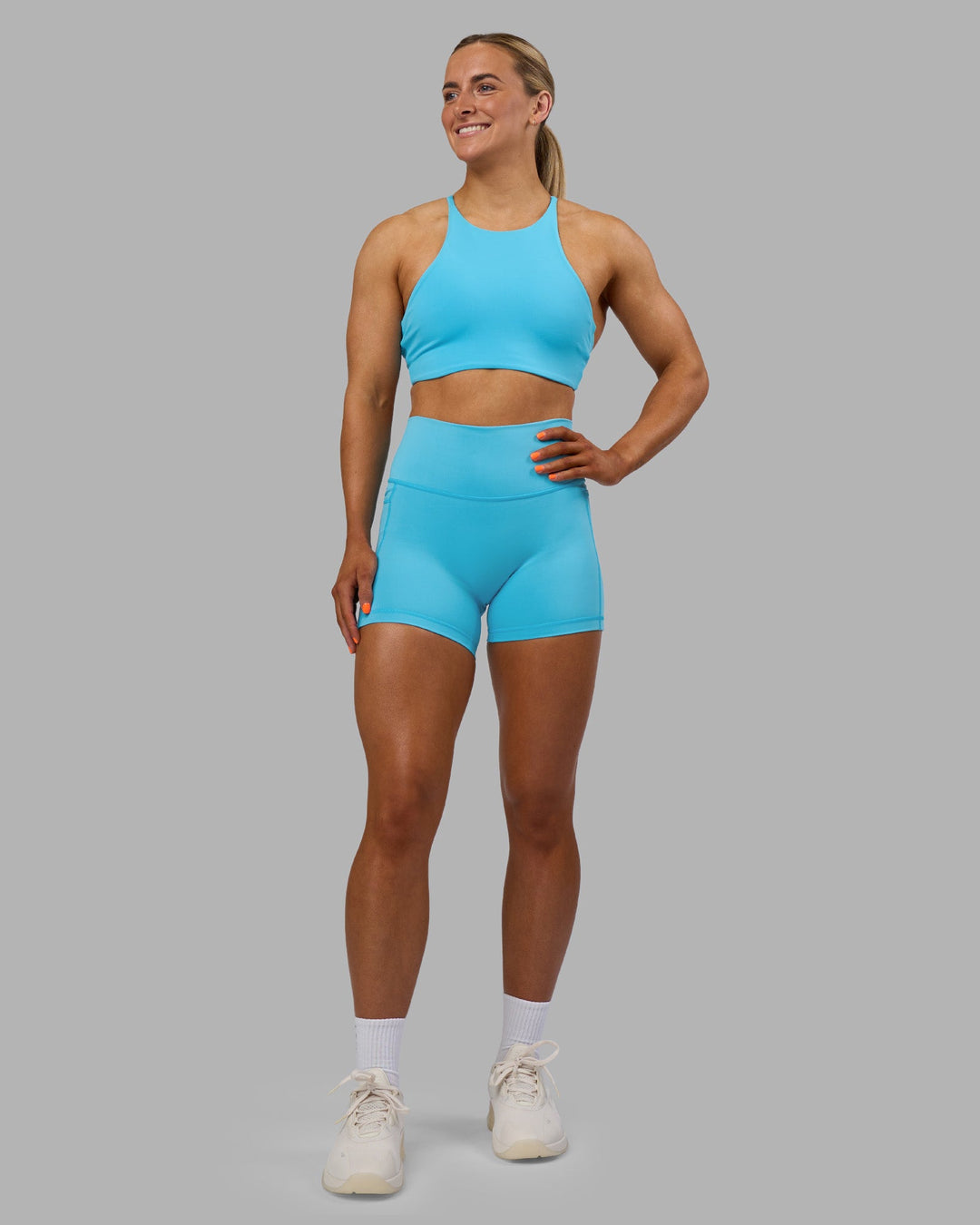 Woman wearing Fusion High-Rise 4" Short Pockets - Blue Atoll | ModelGeorgia | Size:S