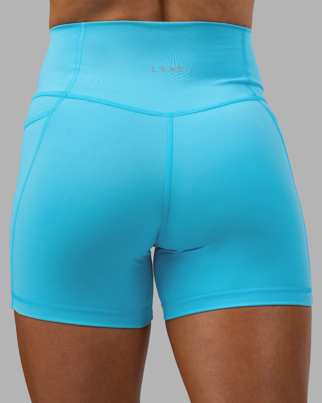 Woman wearing Fusion High-Rise 4&quot; Short Pockets - Blue Atoll | ModelGeorgia | Size:S