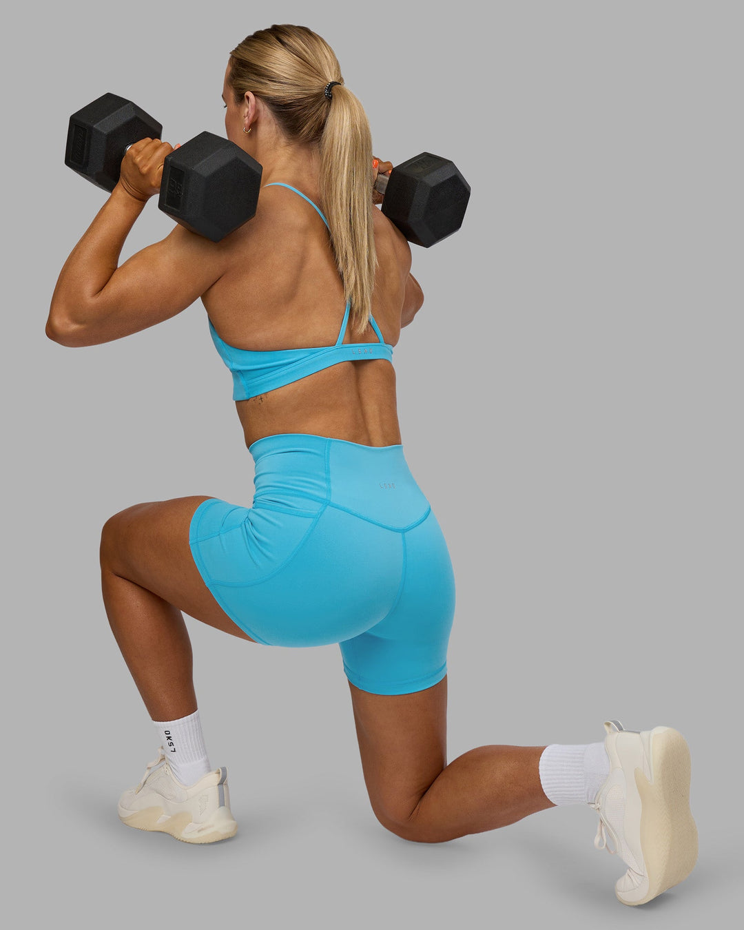 Woman wearing Fusion High-Rise 4&quot; Short Pockets - Blue Atoll | ModelGeorgia | Size:S