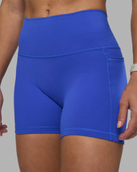 Woman wearing Fusion High-Rise 4" Short Pockets - Power Cobalt | Model:Hannah | Size:S