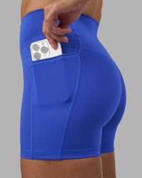 Woman wearing Fusion High-Rise 4" Short Pockets - Power Cobalt | Model:Hannah | Size:S