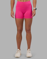 Woman wearing Fusion High-Rise 4" Short Pockets - Ultra Pink | Model:Hannah | Size:S