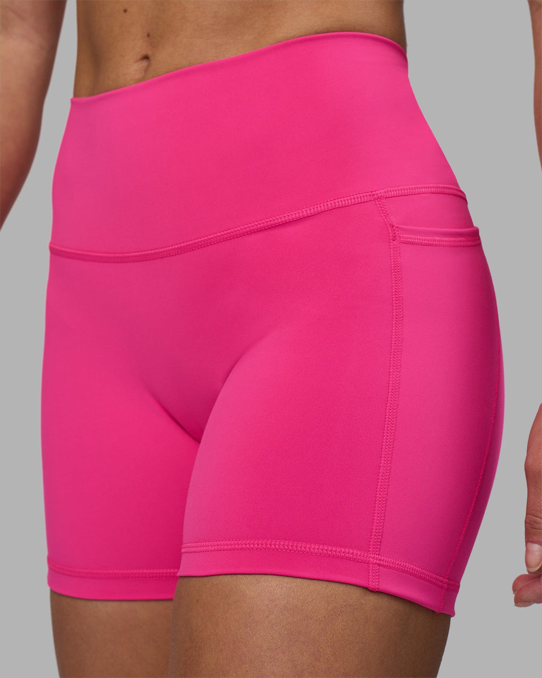 Woman wearing Fusion High-Rise 4&quot; Short Pockets - Ultra Pink | Model:Hannah | Size:S