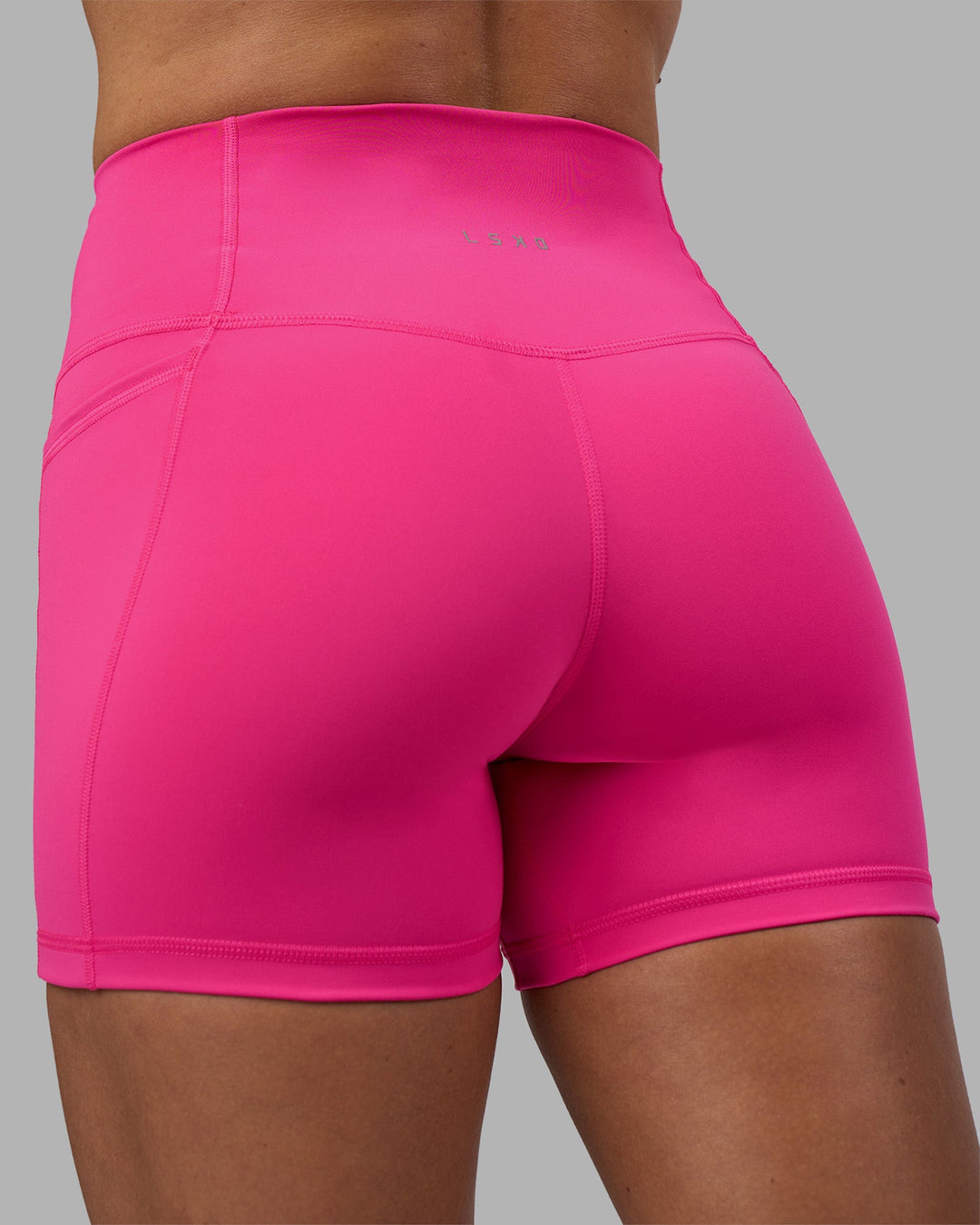Woman wearing Fusion High-Rise 4&quot; Short Pockets - Ultra Pink | Model:Hannah | Size:S