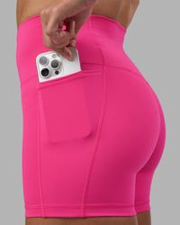 Woman wearing Fusion High-Rise 4" Short Pockets - Ultra Pink | Model:Hannah | Size:S