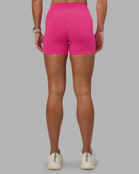 Woman wearing Fusion High-Rise 4" Short Pockets - Ultra Pink | Model:Hannah | Size:S