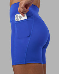 Woman wearing Fusion High-Rise 6" Short Pockets - Power Cobalt | Model:Hannah | Size:S