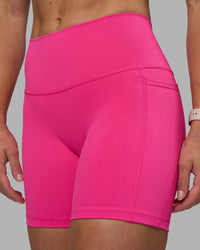 Woman wearing Fusion High-Rise 6" Short Pockets - Ultra Pink | Model:Hannah | Size:S
