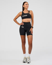 Woman wearing Fusion Hype Graphic Ultra High-Rise 6" Short Pockets - Black-Alloy | Model:Rhiley | Size:S