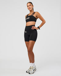 Woman wearing Fusion Hype Graphic Ultra High-Rise 6" Short Pockets - Black-Alloy | Model:Rhiley | Size:S
