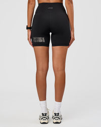 Woman wearing Fusion Hype Graphic Ultra High-Rise 6" Short Pockets - Black-Alloy | Model:Rhiley | Size:S