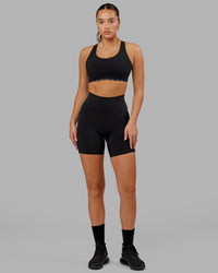 Woman wearing O.G. Fusion Ultra High-Rise 6" Short Pockets - Black | Model:Milly | Size:S