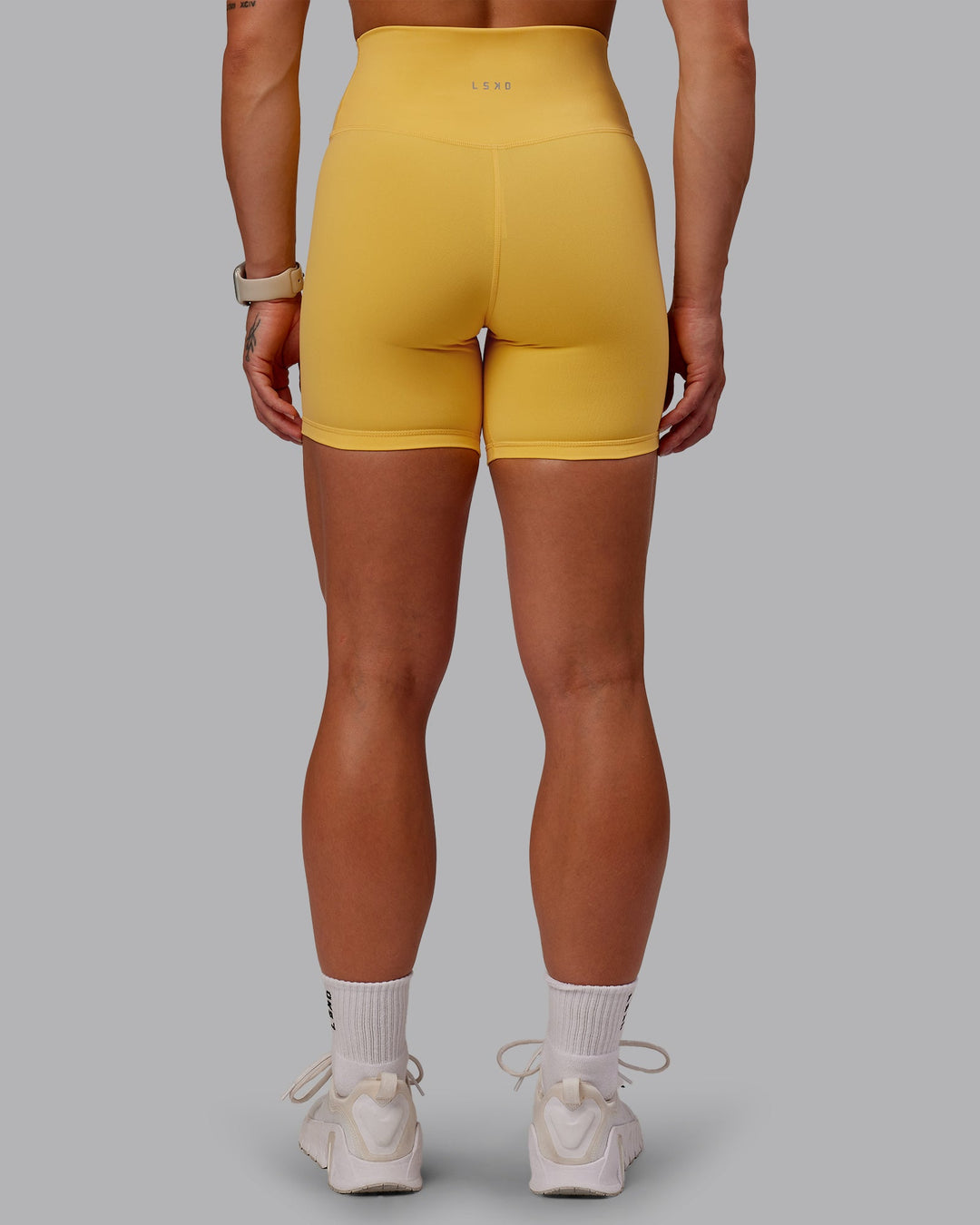 Woman wearing Fusion Mid Short Tight in Banana Cream | Size:S