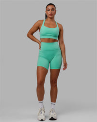 Woman wearing Fusion Ultra High-Rise 6" Short Pockets - Aquatic Awe | Model:Gabby | Size:S