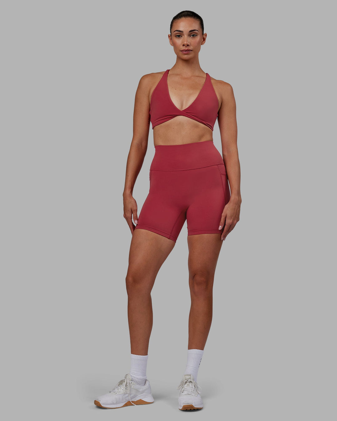 Woman wearing Fusion Ultra High-Rise 6&quot; Short Pockets - Claret | Model:Blaize | Size:S