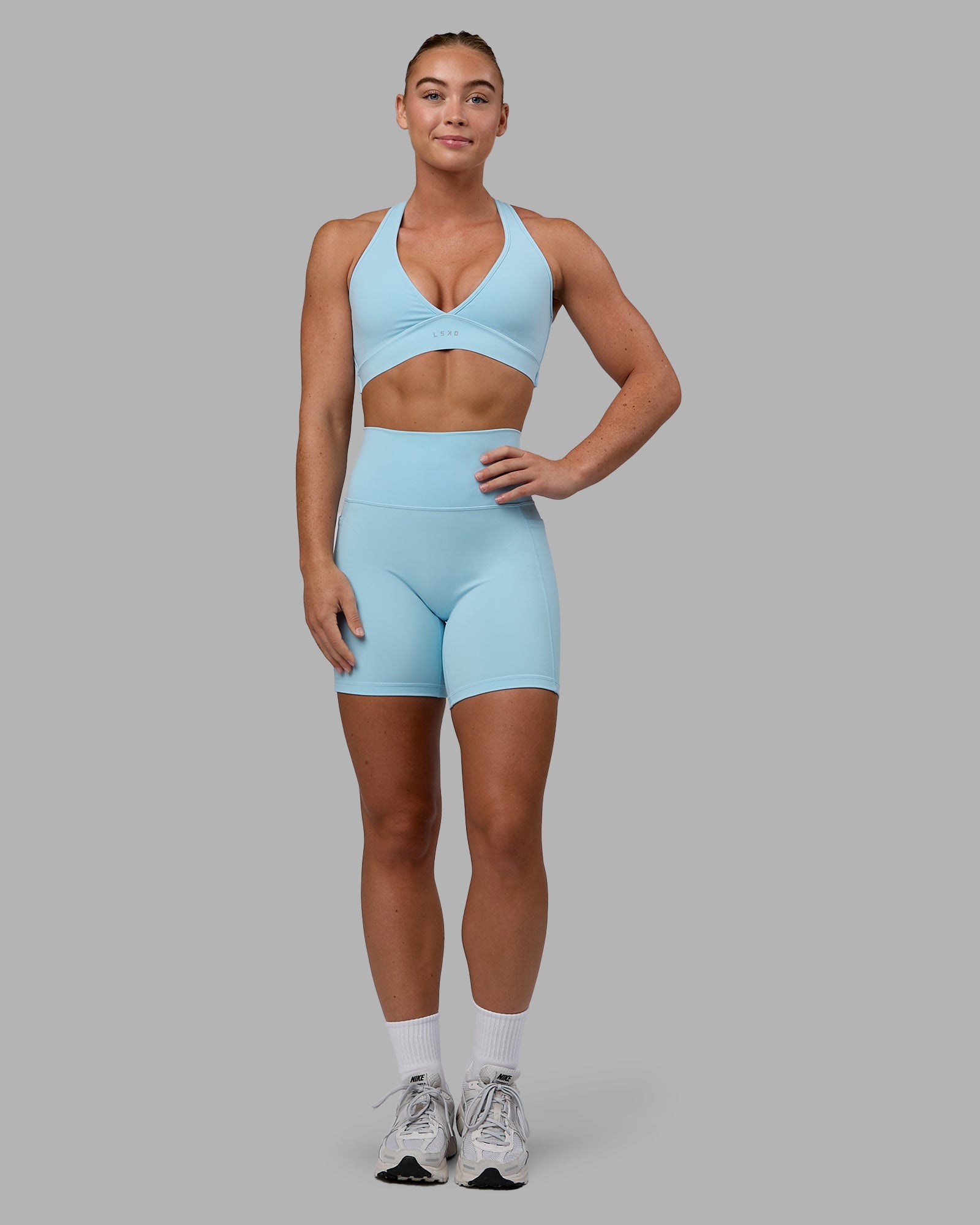 Woman wearing Fusion Ultra High-Rise 6" Short Pockets - Glacial Blue | Model:Monique | Size:S