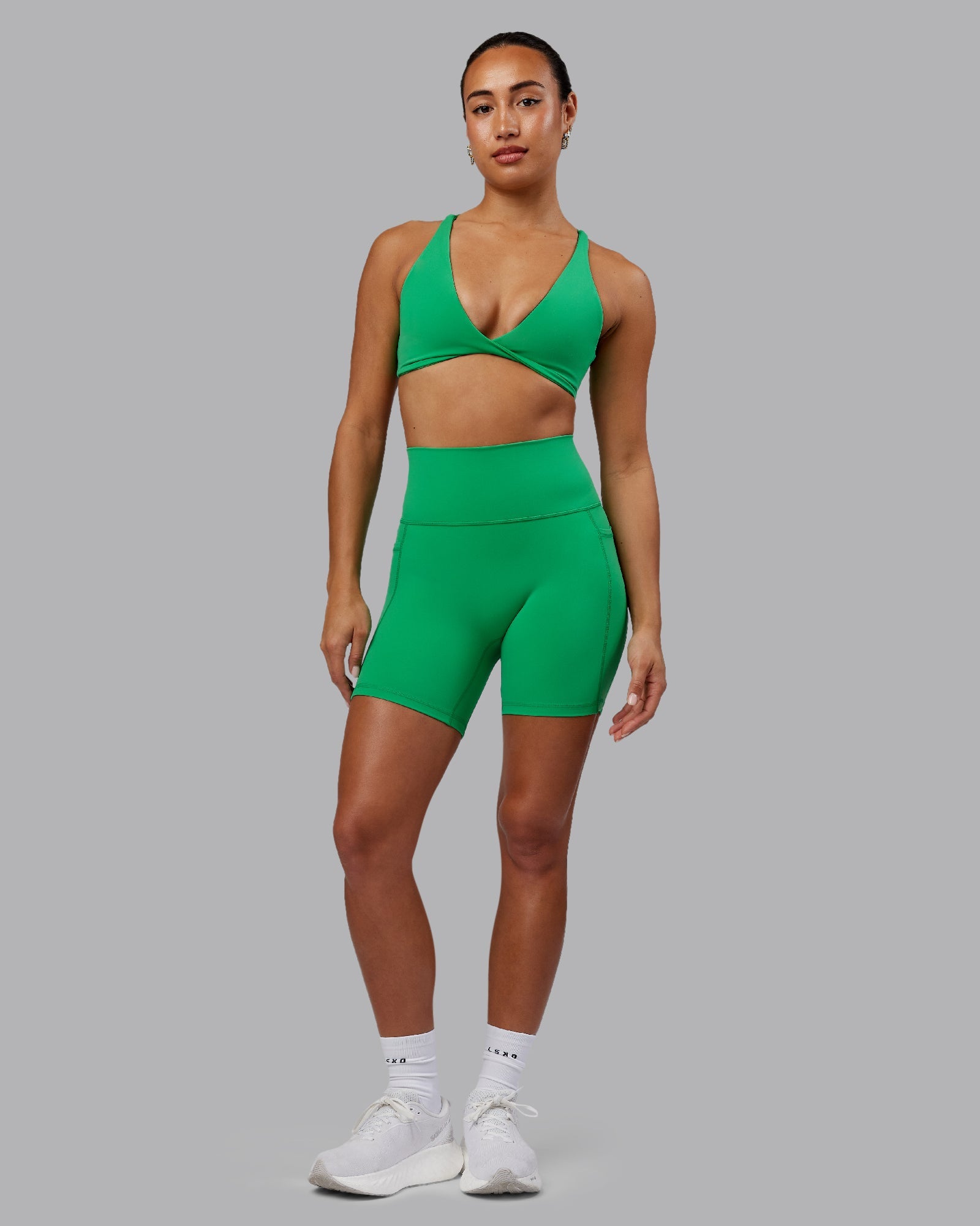Woman wearing Fusion Ultra High-Rise 6" Short Pockets - Impact Green | Model:Demi | Size:S