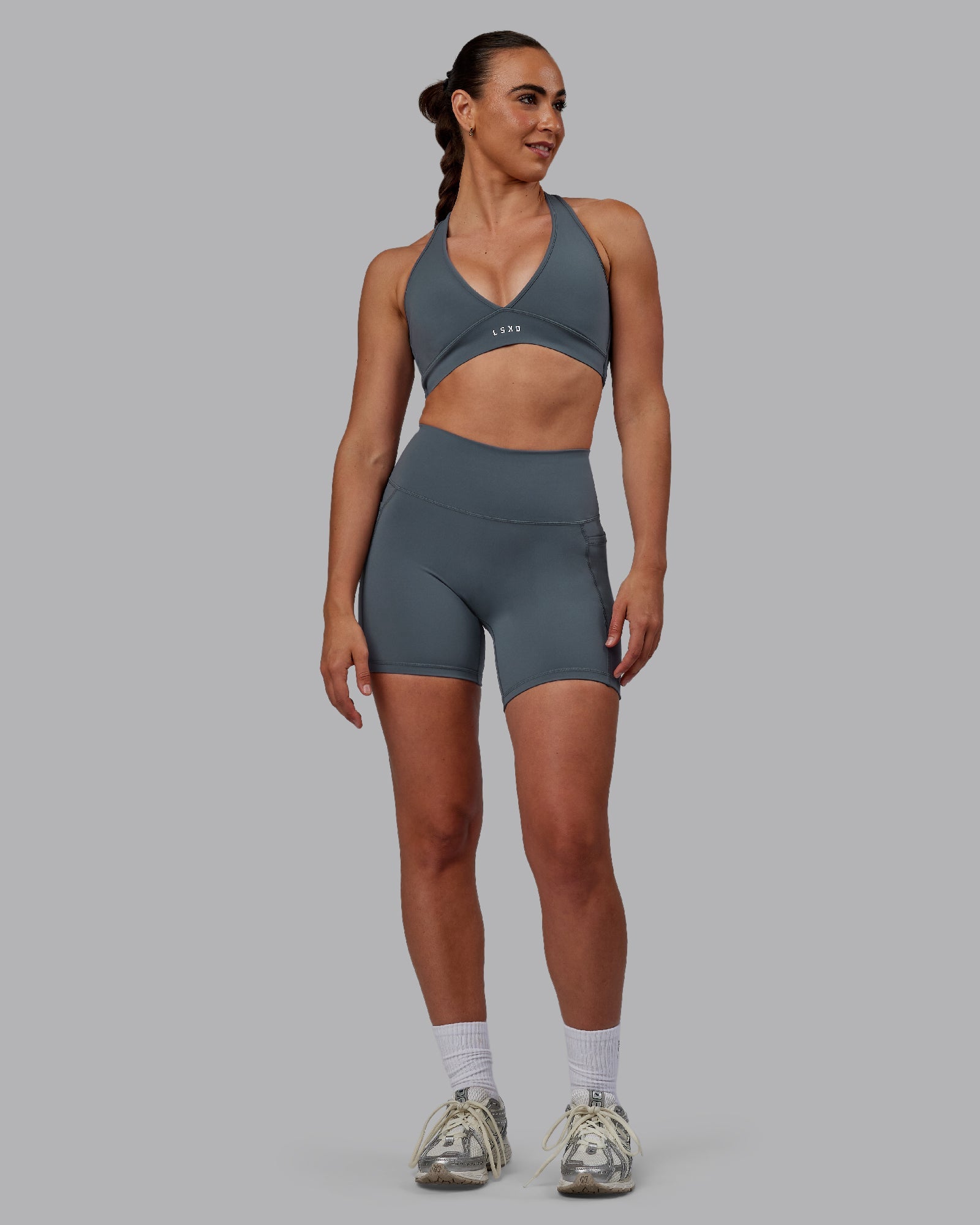 Woman wearing Fusion Ultra High-Rise 6" Short Pockets - Turbulence | Model:Sophie | Size:S