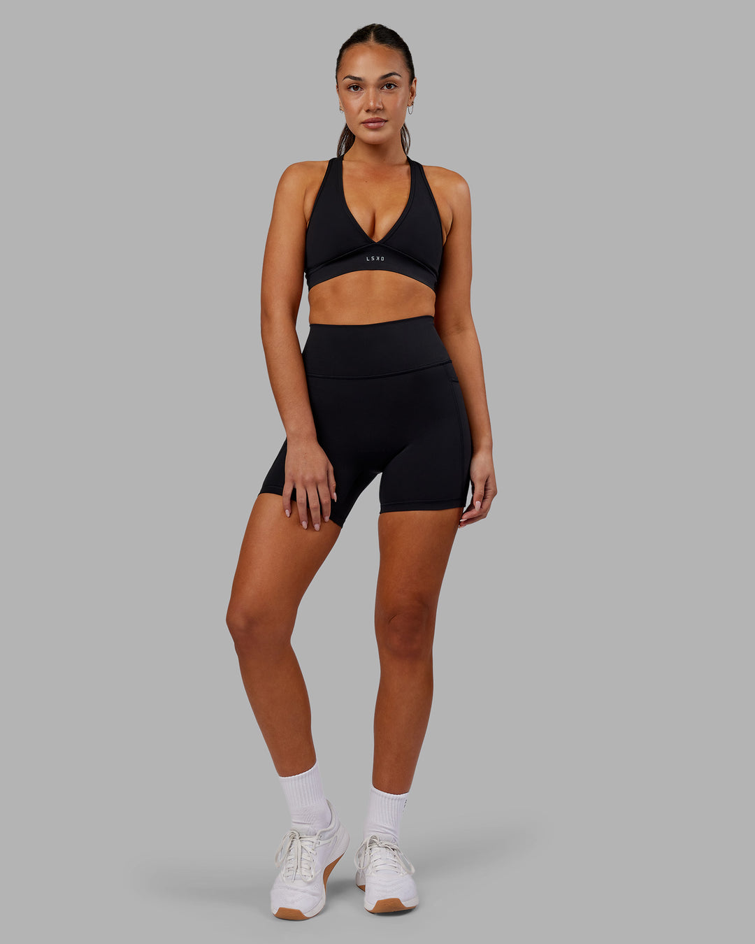 Woman wearing Fusion Ultra High-Rise 6" Short Pockets - Black | Model:Kirstyn | Size:S