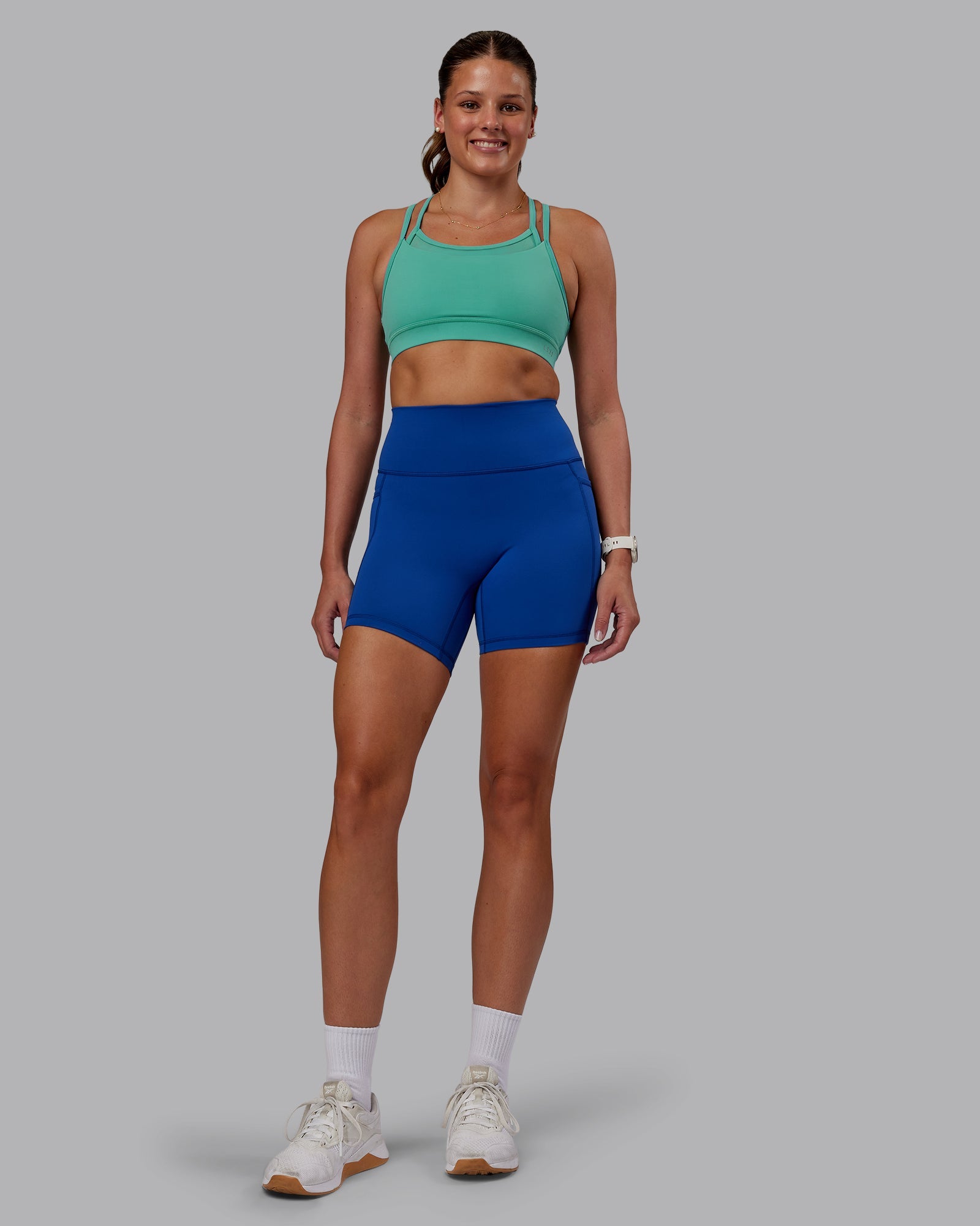 Woman wearing Fusion Ultra High-Rise 6" Short Pockets - Blue Quartz | Model:Phoebe | Size:S