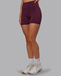 Woman wearing Fusion Ultra High-Rise 6" Short Pockets - Cherry Lacquer | Set:true | Angle:side | Model:Paris | Size:S