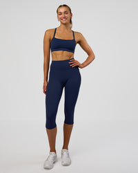 Woman wearing Fusion Ultra High-Rise 3/4 Legging Pockets - Future Navy | Model:Evie | Size:S