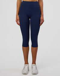 Woman wearing Fusion Ultra High-Rise 3/4 Legging Pockets - Future Navy | Model:Evie | Size:S