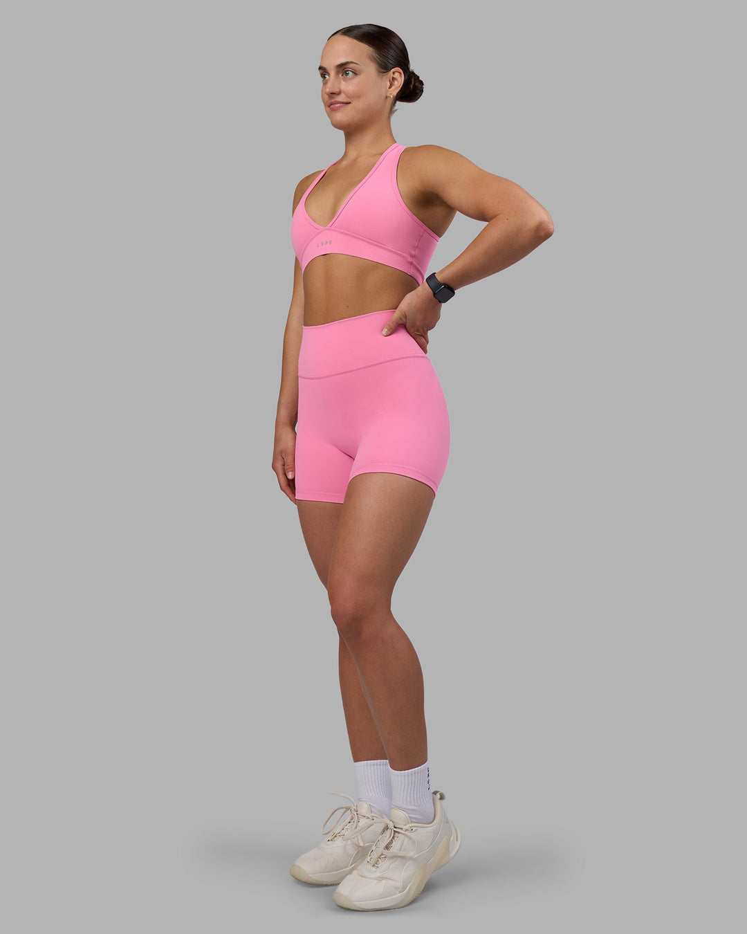 Woman wearing Fusion Ultra High-Rise 4&quot; Short - Candy Pink | Model:Keisha | Size:S