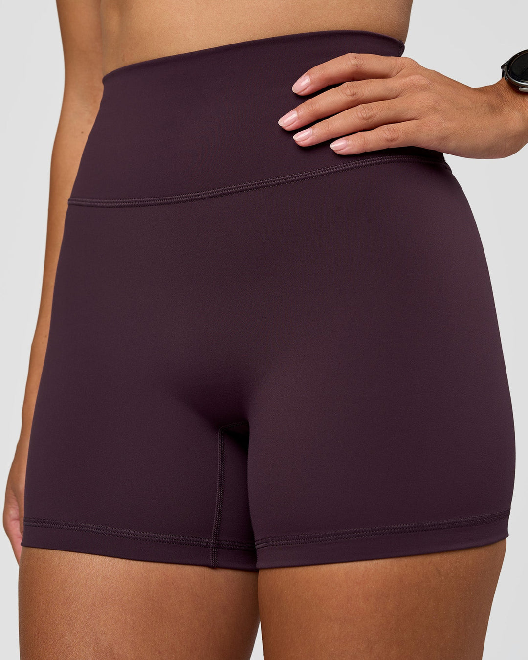 Woman wearing Fusion Ultra High-Rise 4" Short - Midnight Plum | Set:true | Angle:closeup | Model:Rhiley | Size:S