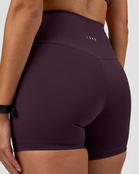 Woman wearing Fusion Ultra High-Rise 4" Short - Midnight Plum | Model:Rhiley | Size:S